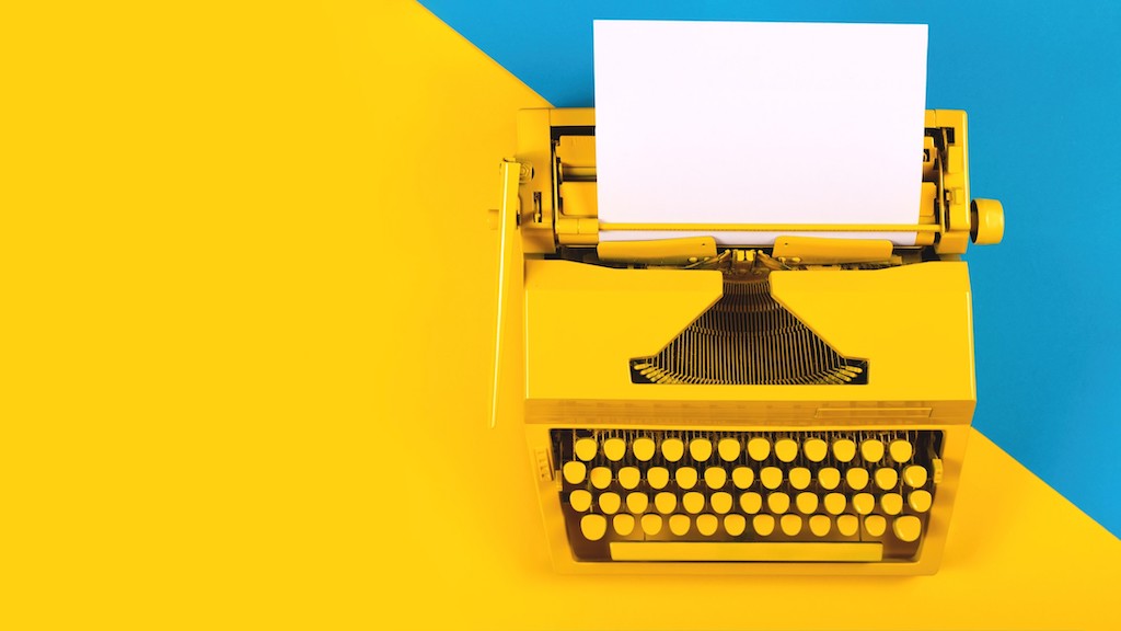 Typewriter in different colors. How To Improve Content Marketing With Topic Clusters.