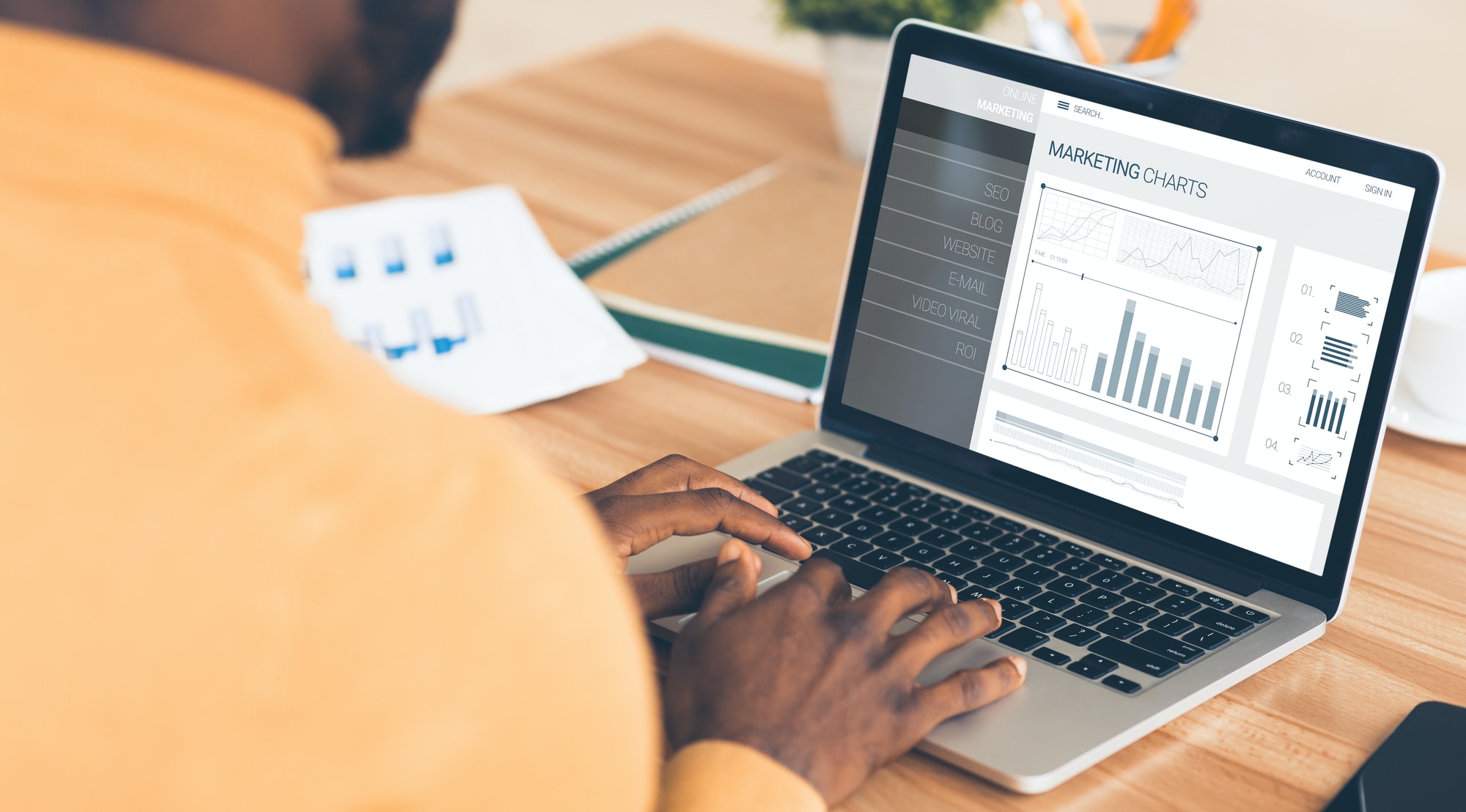 Businessman At Laptop Working With Internet Marketing Charts. 8 SEO Tips That Will Drive More Traffic To Your Site.