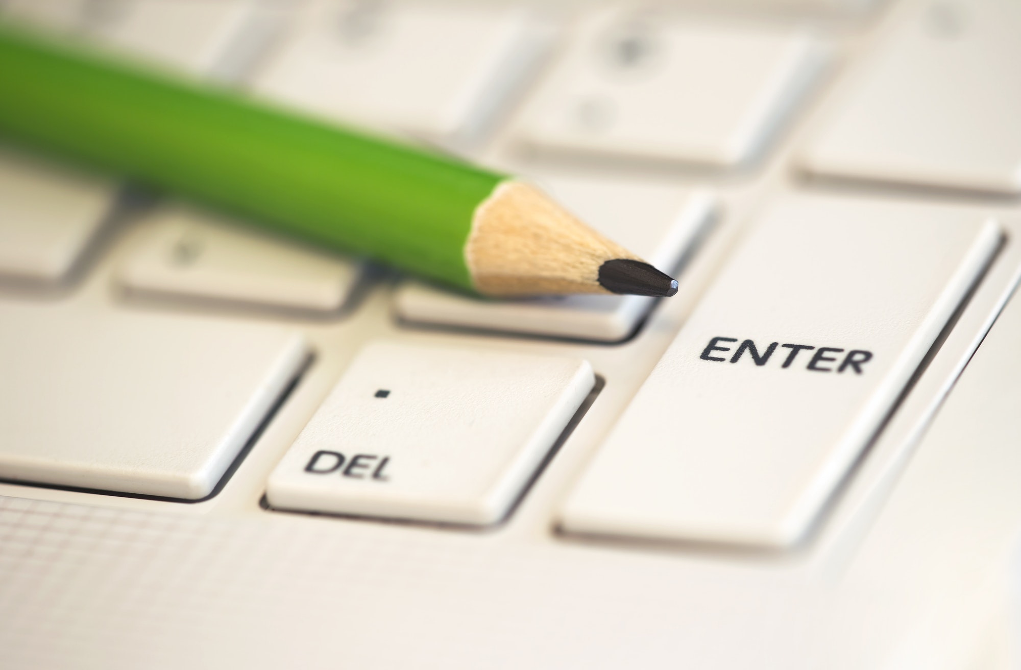 A pencil on a keyboard. Important tips to remember when creating your online course.