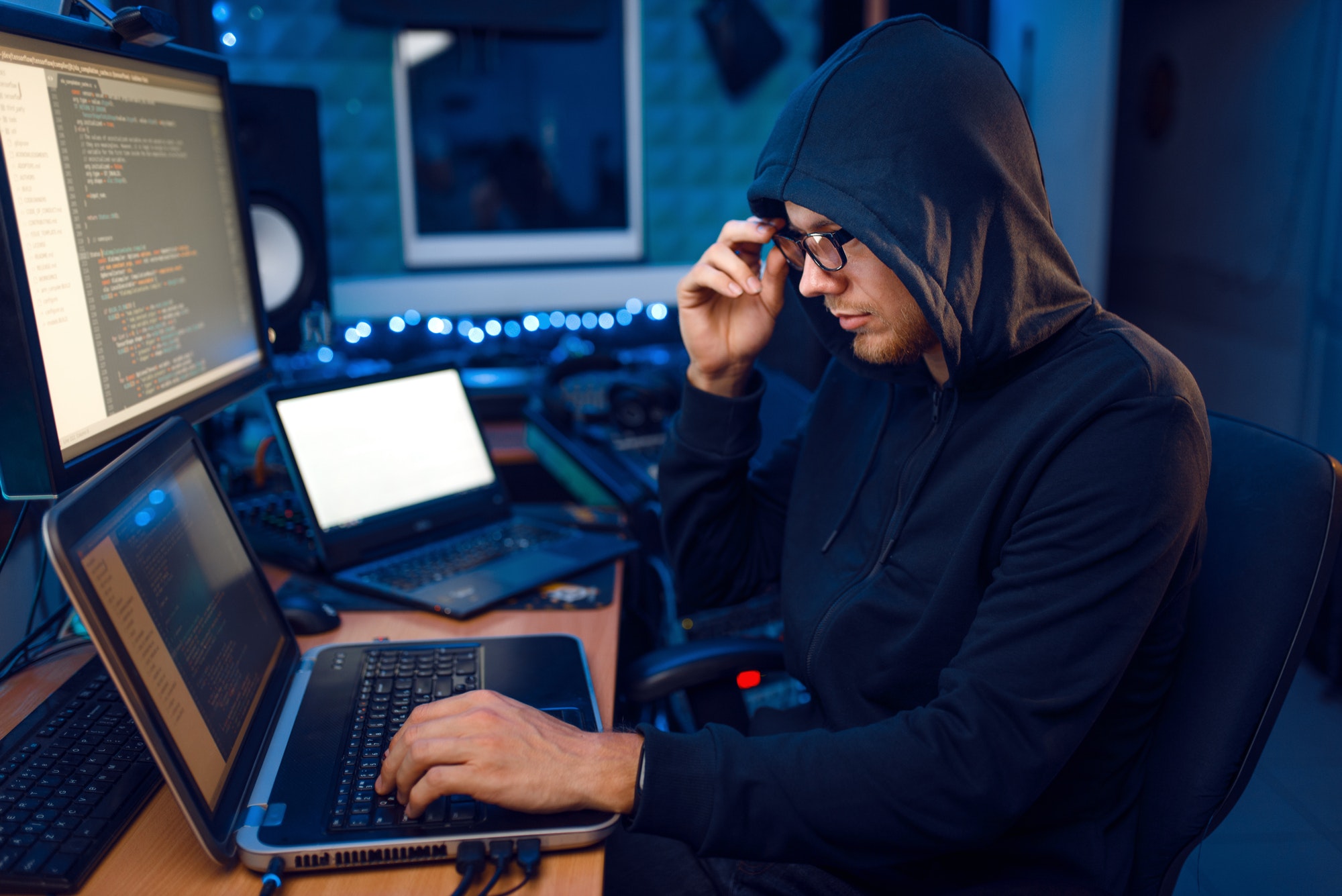 Improve Identity Management And Overall Website Security | Matchbox Design Group | St. Louis, MO Hacker in hood at his workplace. The Impact Of Blockchain will improve security.