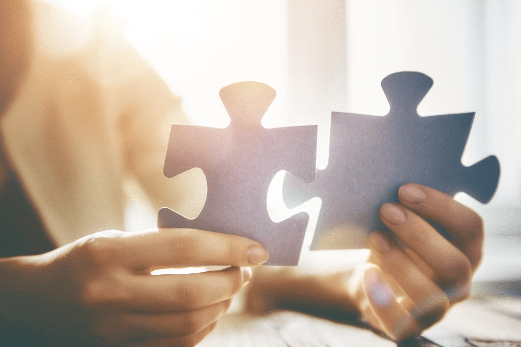 Off-page SEO Tips & Strategies | St. Louis SEO Agency - Matchbox Design Group Person putting puzzle pieces together representing off-page SEO tips & strategies.