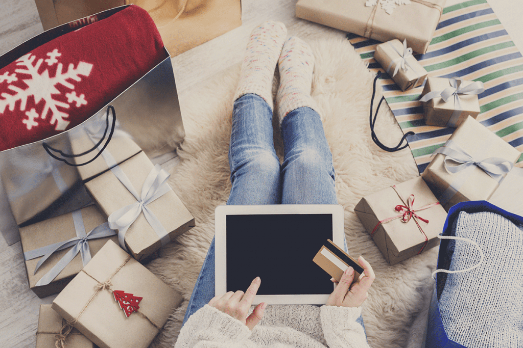 Greater Internet Presence | St. Louis SEO | Matchbox Design Group Woman using her iPad for an eCommerce purchase. Top 10 benefits of SEO.