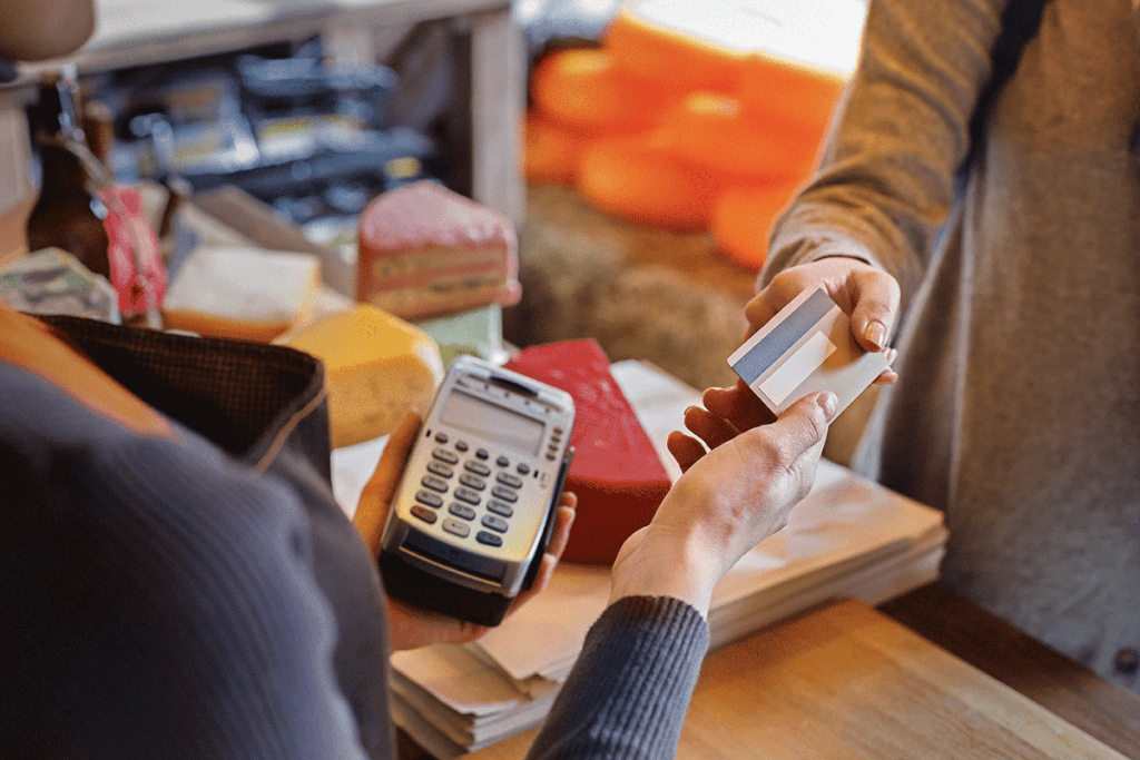 SEO For Local Businesses | Matchbox Design Group | St. Louis, MO How To Optimize For Local SEO. SEO For Local Businesses. Person paying a cashier.