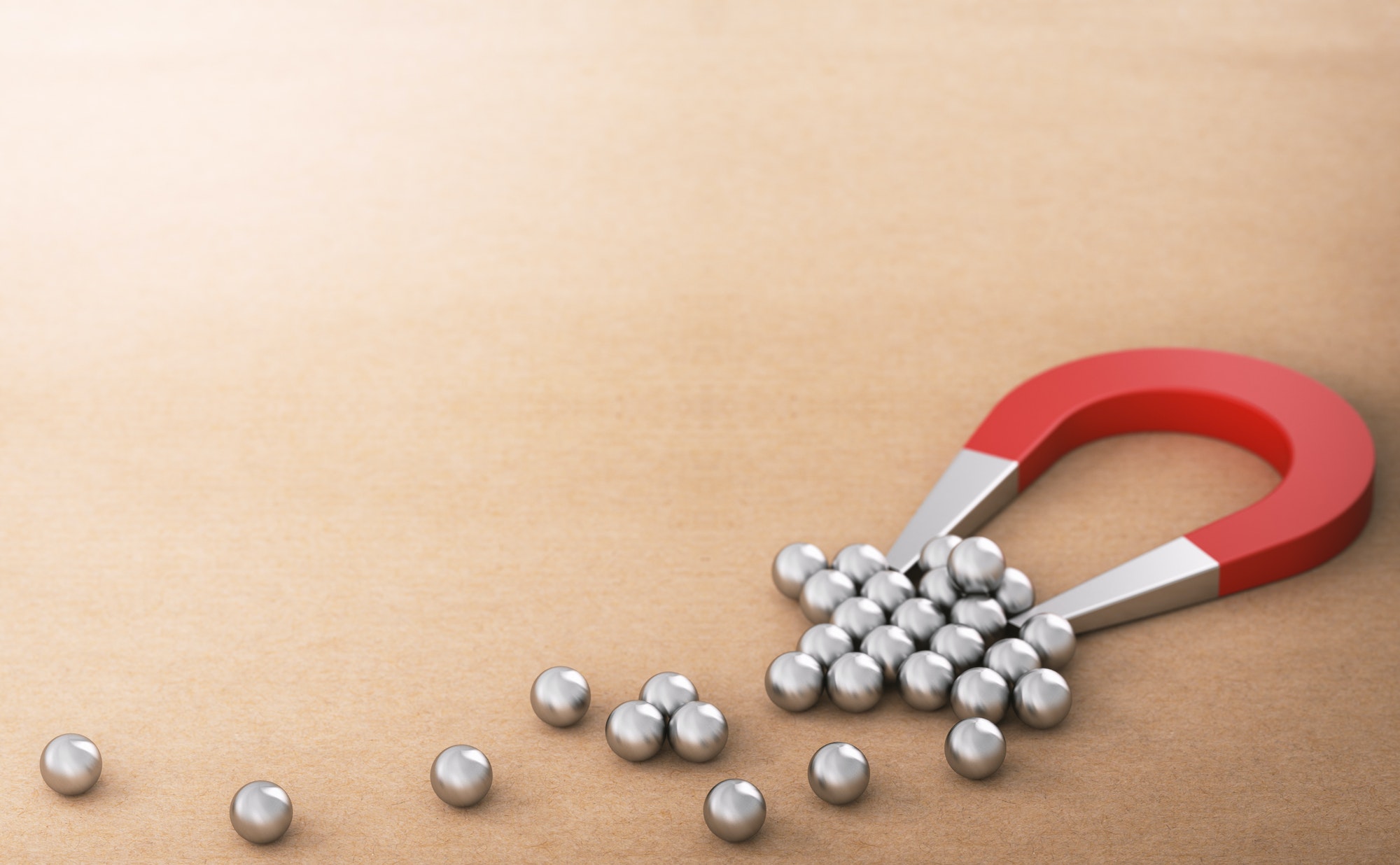 Customer retention illustrated by a magnet and marbles.