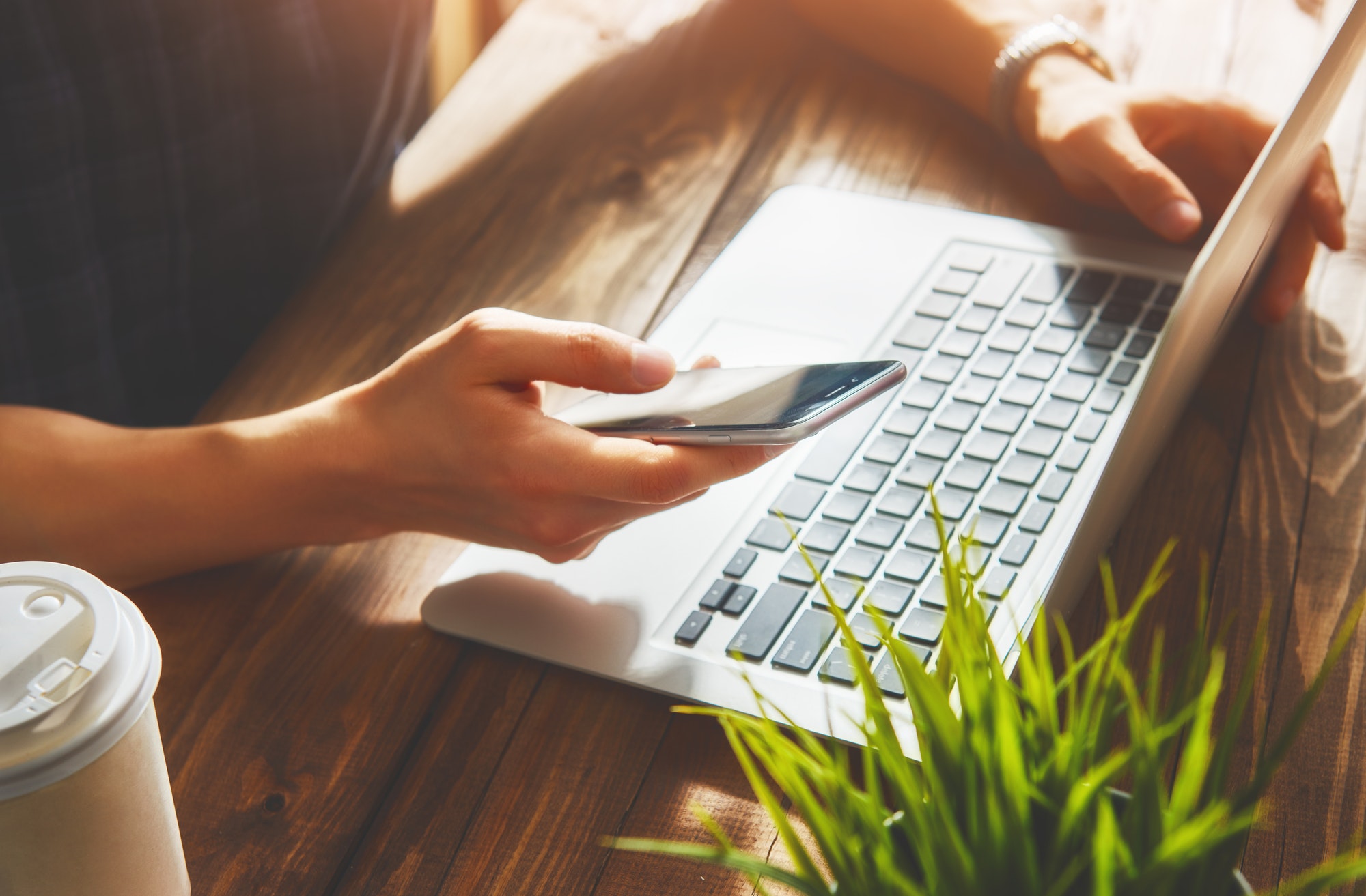 Man is using his phone to check his email after creating an optimized mobile email marketing campaign.