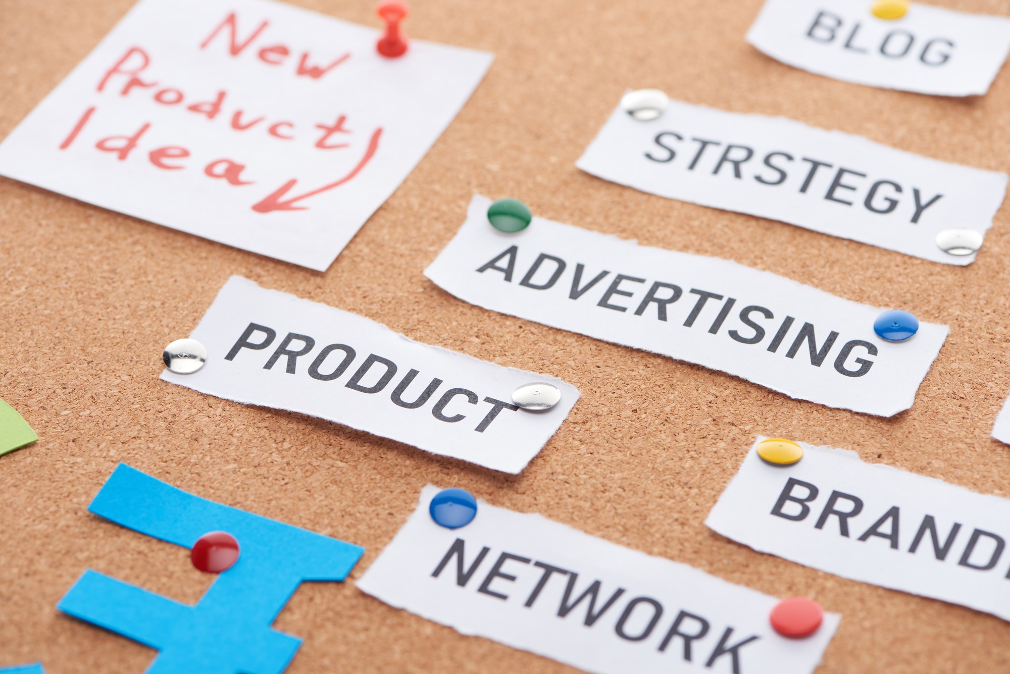 Paper Card With New Product Idea, Advertising, Blog,network Inscriptions Pinned on Cork Office Board.
