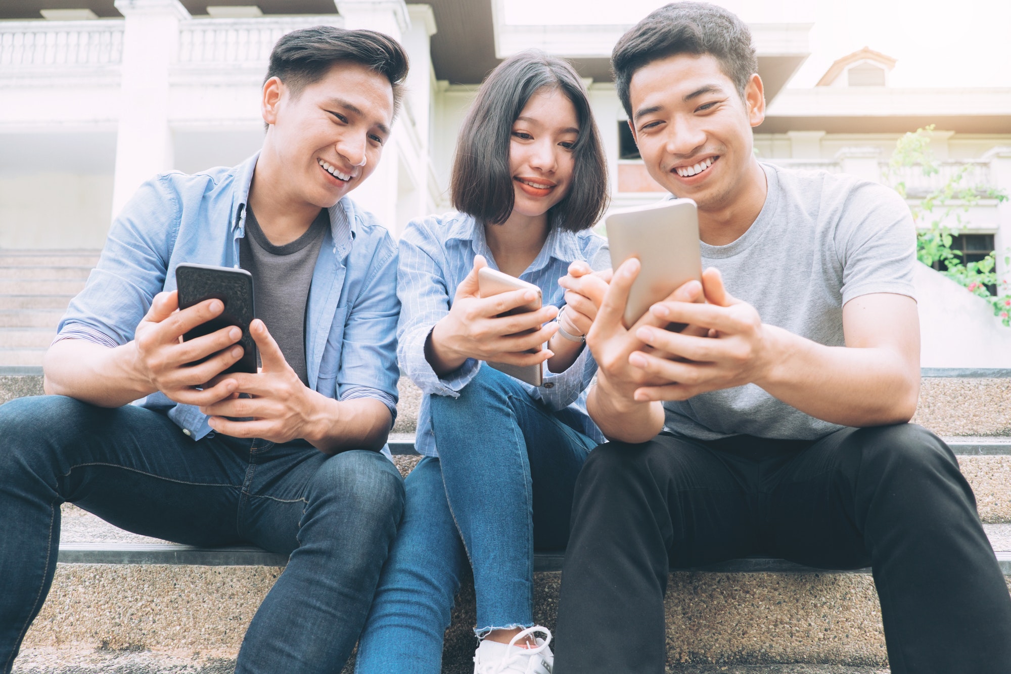 Creative Ways On How To Engage And Market To Teens In 2022. Teens on their phones.