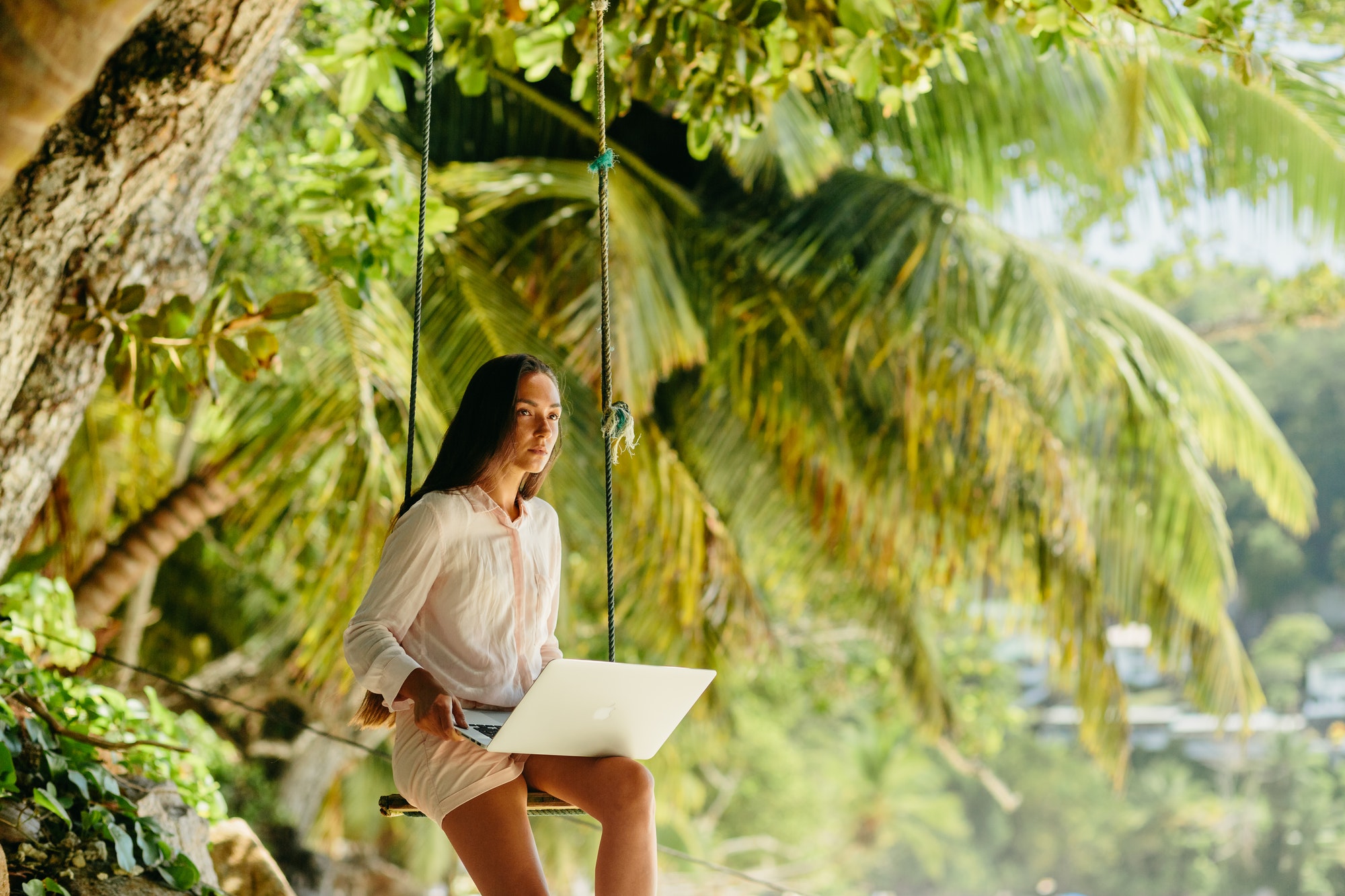 Woman freelancer on the beach.