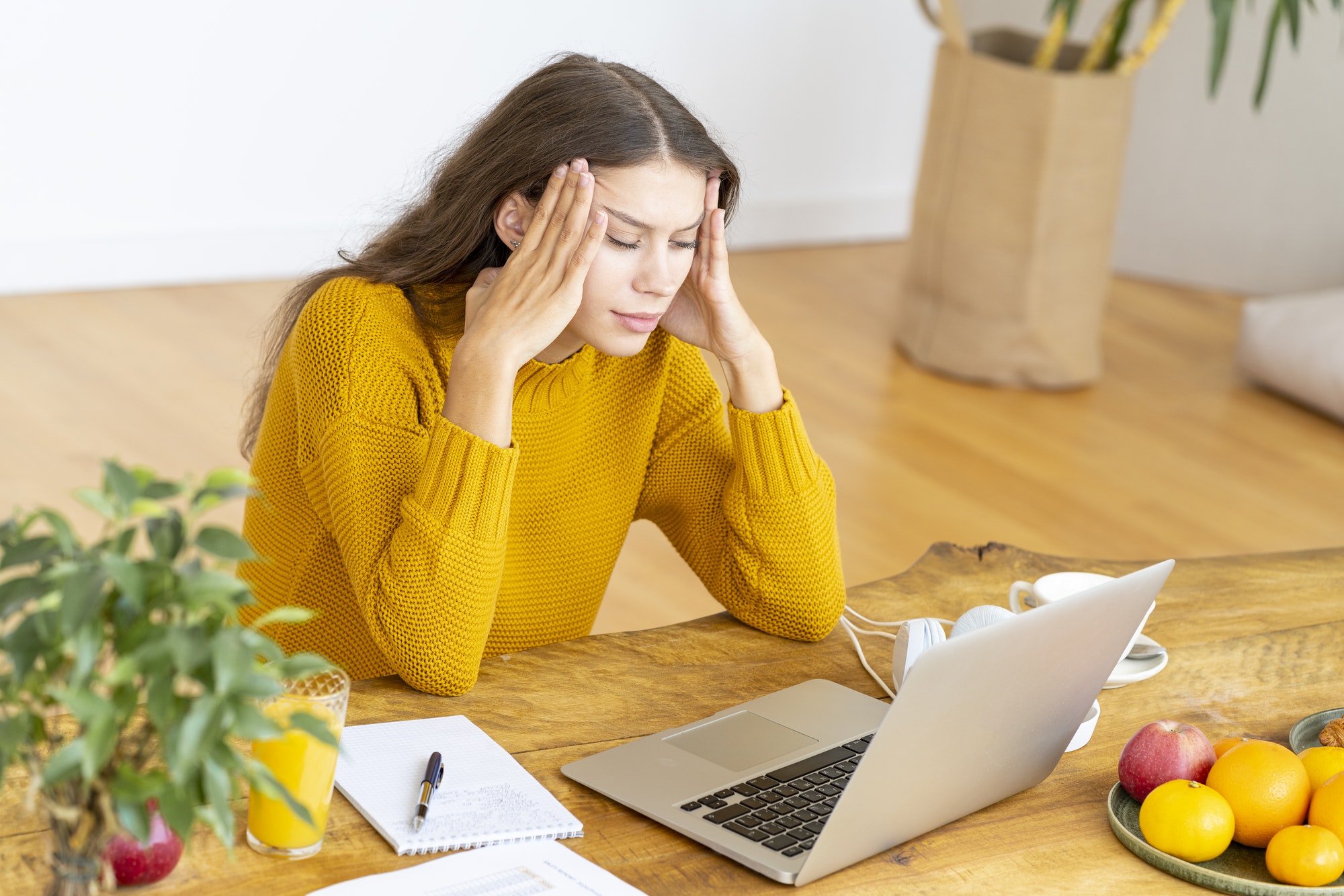 Slow computer is giving this girl a headache.