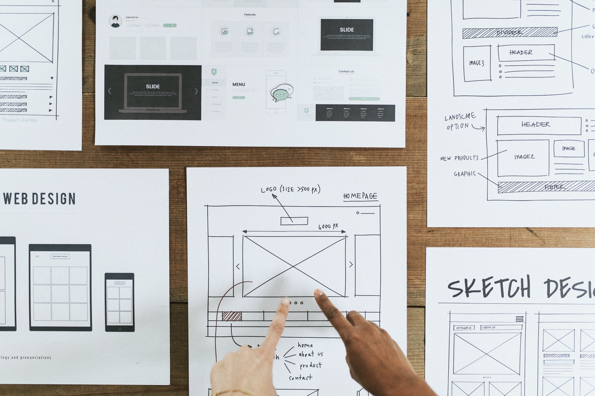 Sketching out a new web design on paper to help not make mistakes.