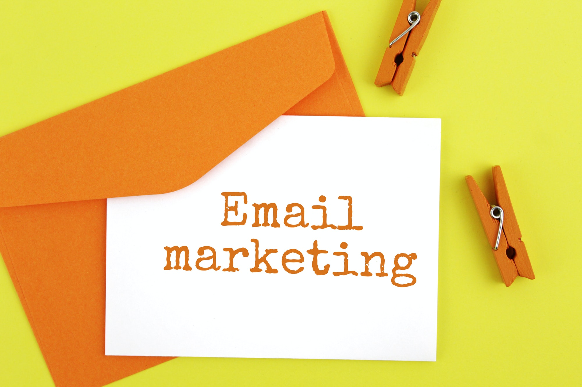 Email marketing written on a note with an envelope. The travel marketer's guide to email marketing.