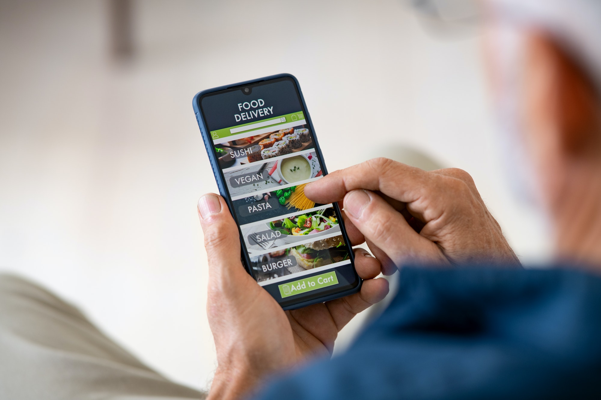 Man using mobile app. It's important to optimize your mobile apps.