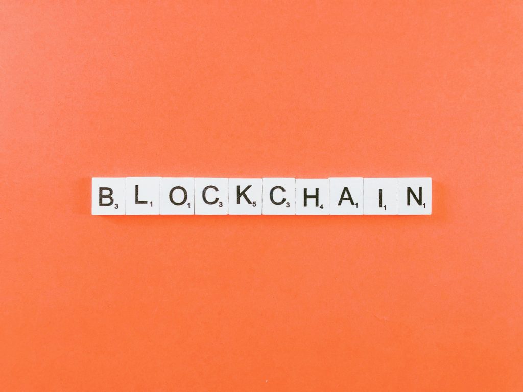 The Blockchain | St. Louis Marketing Agency | Matchbox Design Group Blockchain in letter blocks with orange background.
