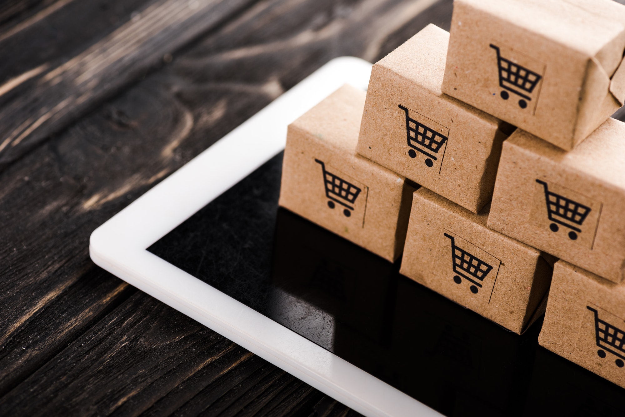 eCommerce Boxes On Tablet. The Impact Of Digital Marketing Channels On eCommerce.