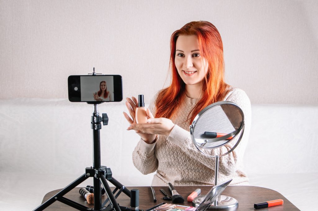 influencer-partnerships Woman beauty blogger records video content on her smartphone for your vlog. Modern influencer