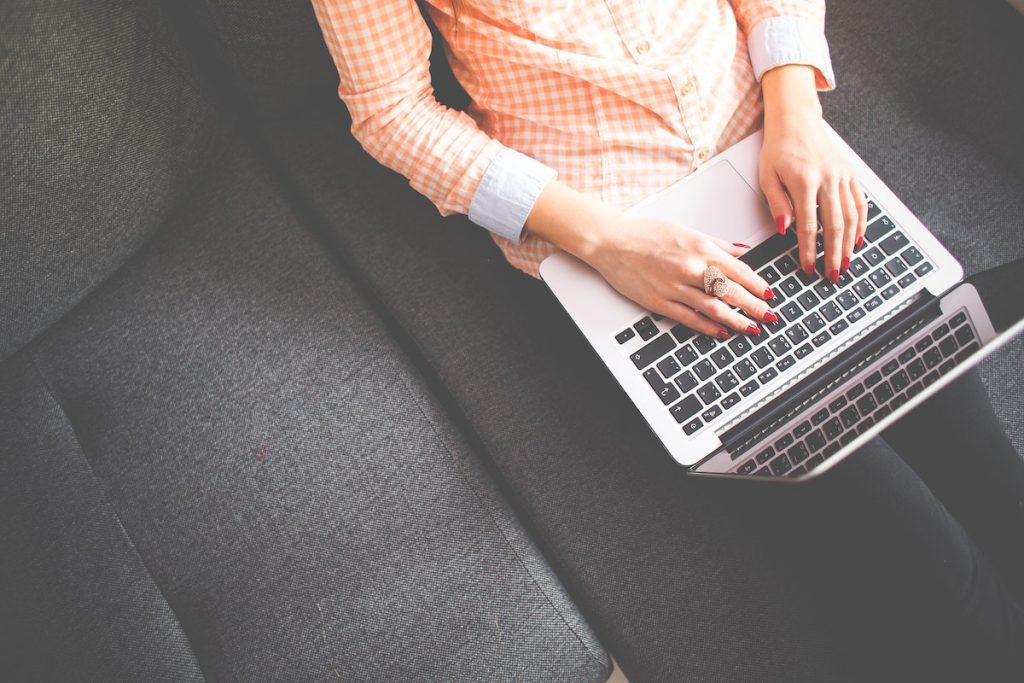 How To Build A Website That Propels Your Business | Matchbox Design Group Woman on her laptop learning how to build a website that propels your business,