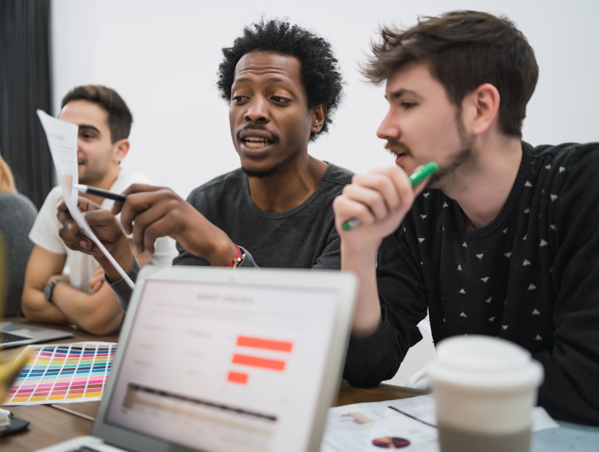Creative designers working on ways to pick the best creative to win over customers.