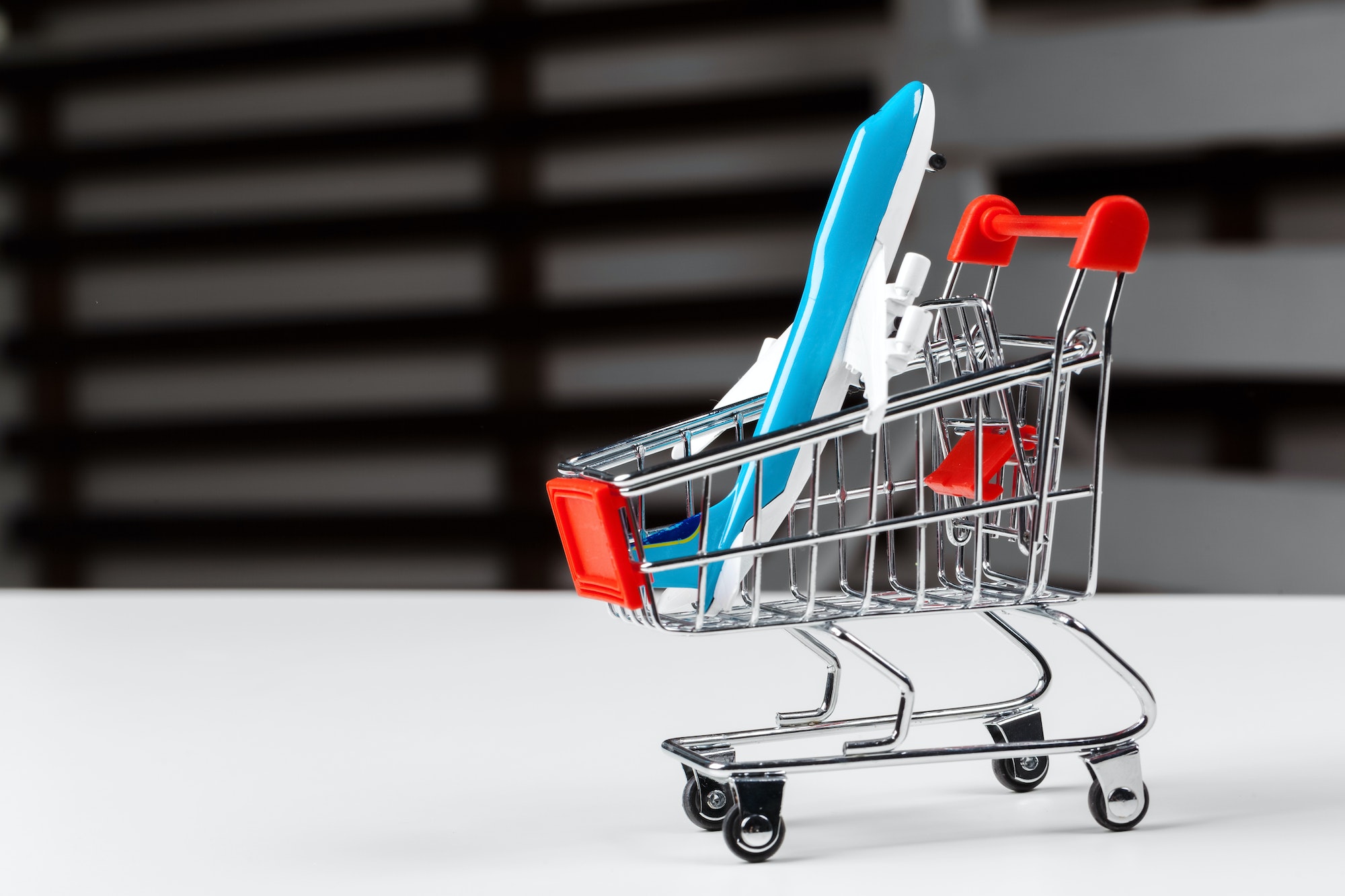 Shopping trolley with toy aircraft representing mapping out your customer journey.