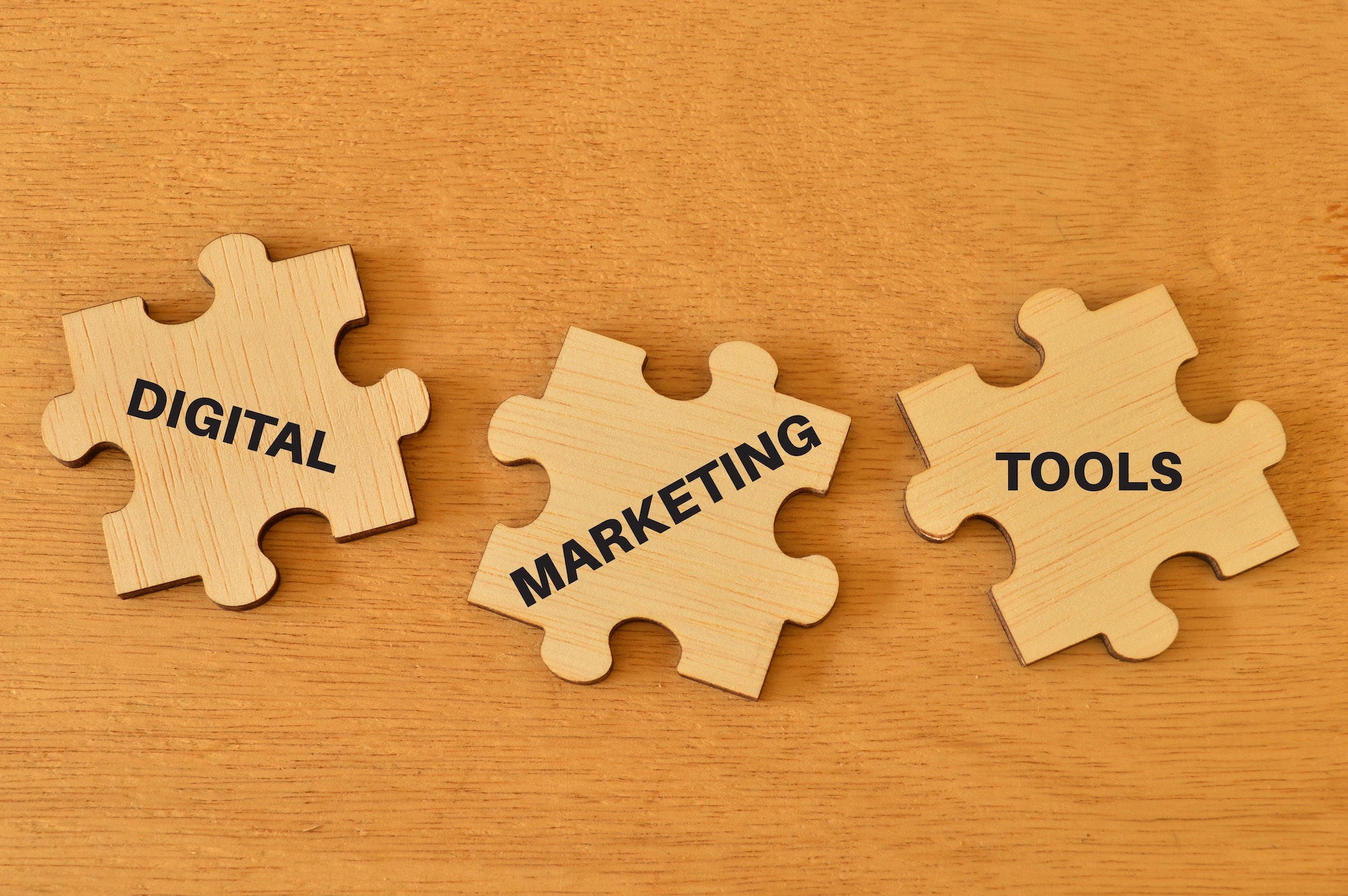 Wooden jigsaw puzzle with text DIGITAL MARKETING TOOLS. What Are The Benefits Of SEO Services?