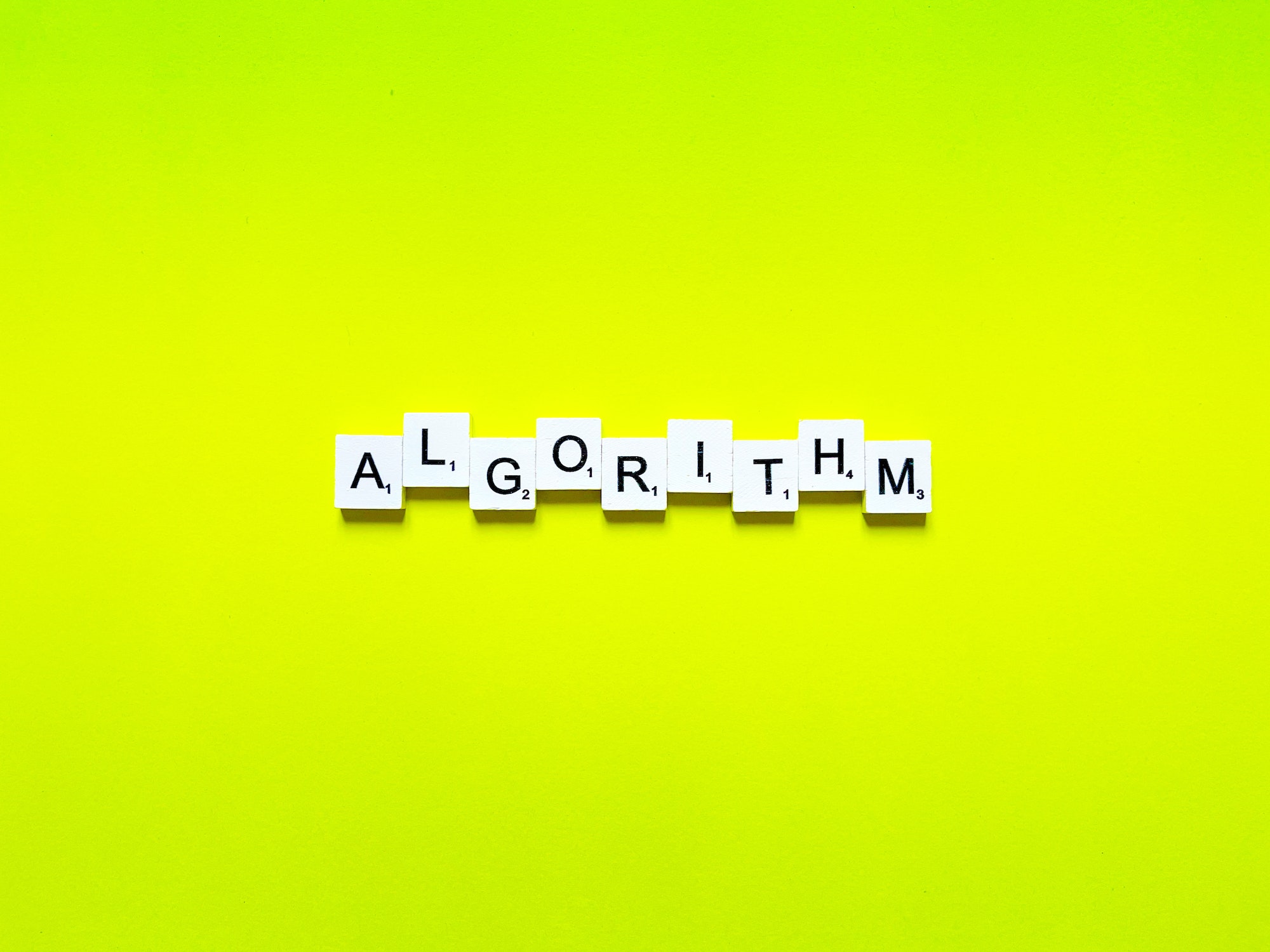 Algorithm written in scrabble letters with a lime green background.