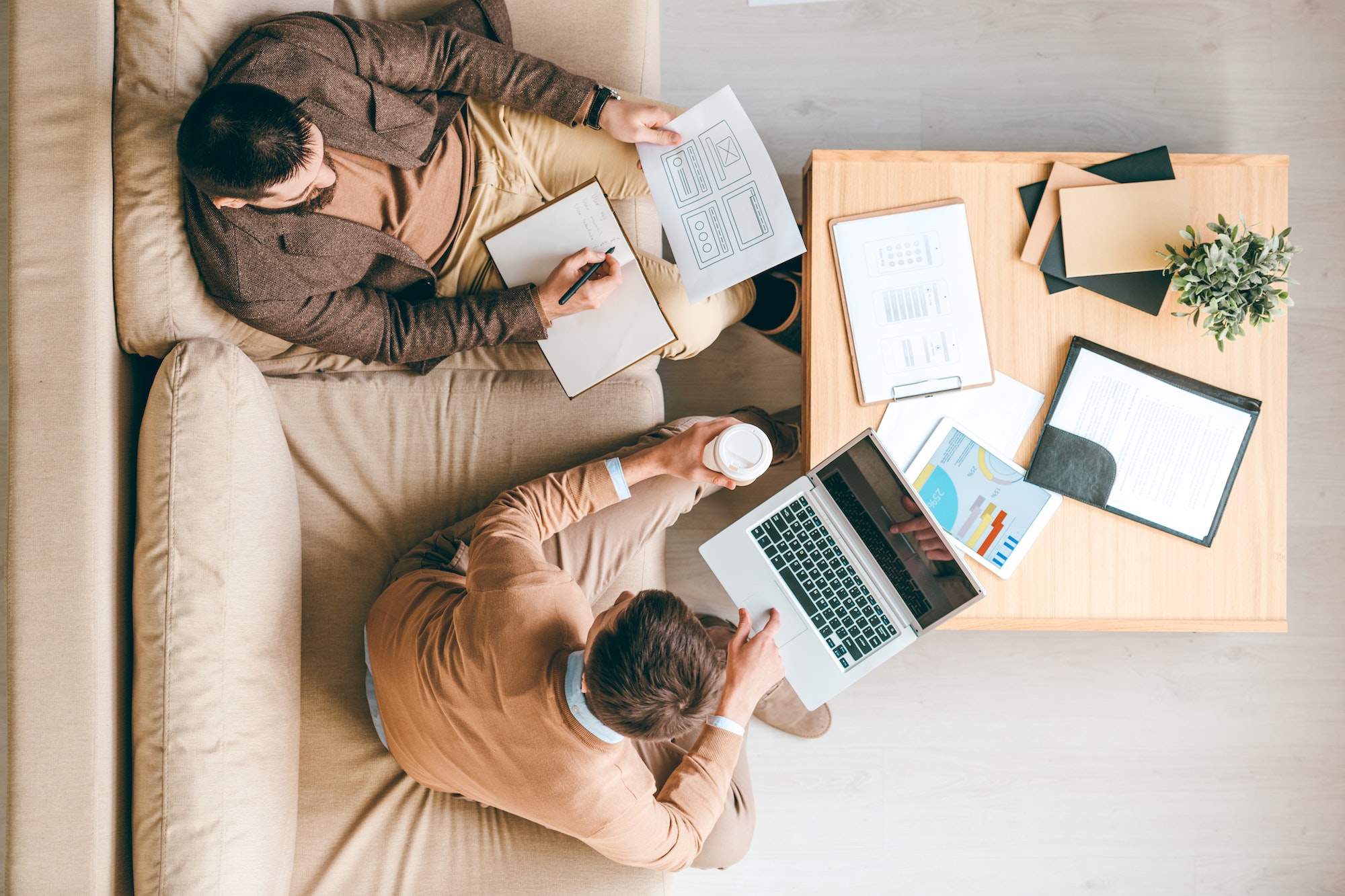 Two people working on a digital brand identity. View from above.