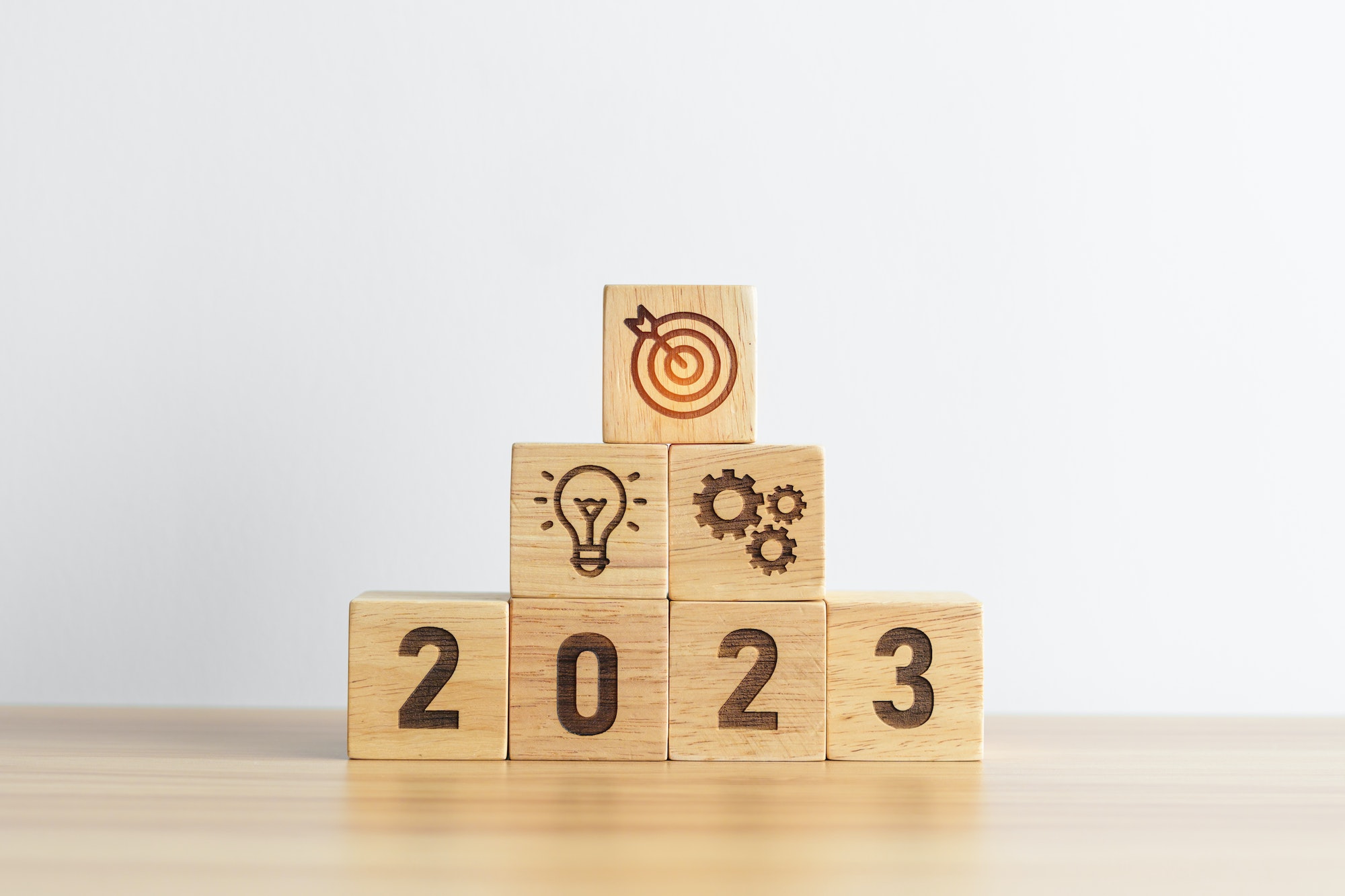 Wood blocks representing a growing business in 2023.