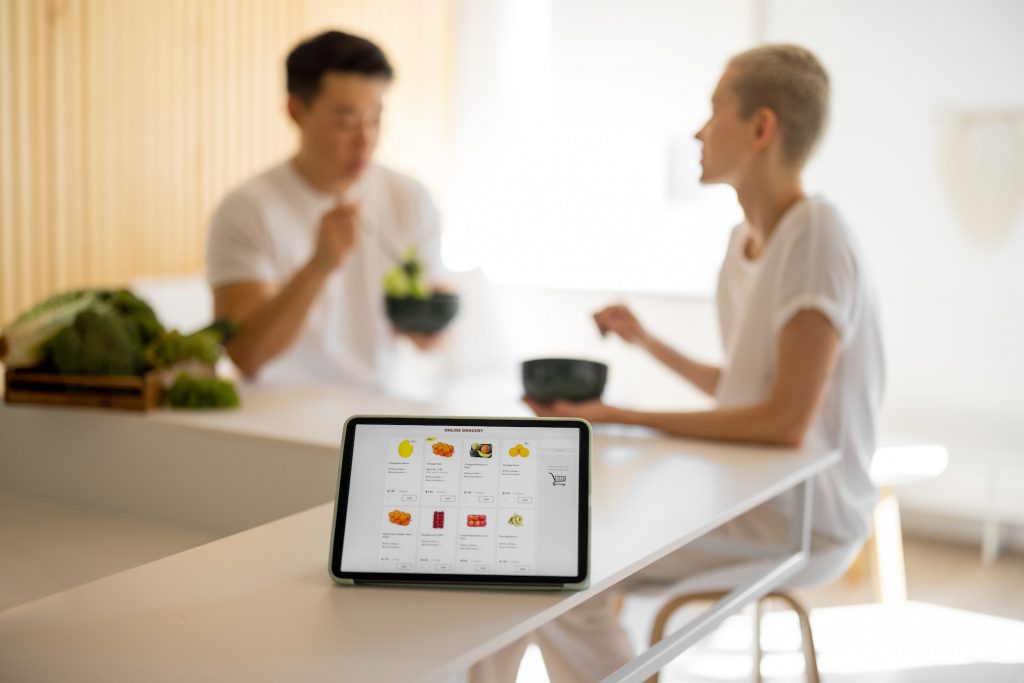 Ecommerce vs. Retail: Which One Is Best For Business? | Matchbox Design Group | St. Louis, MO Tablet with grocery e-commerce store on it