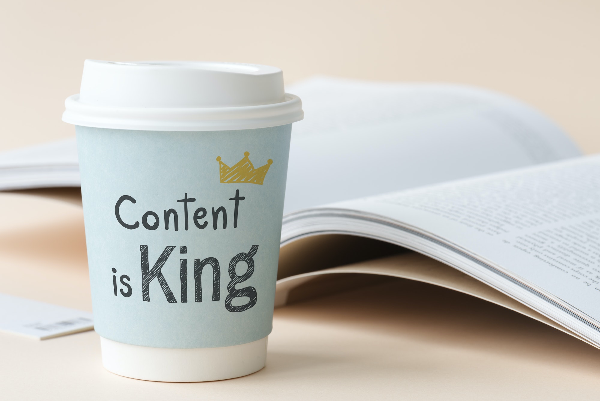 Coffee cup mockup that says Content Is King on it.
