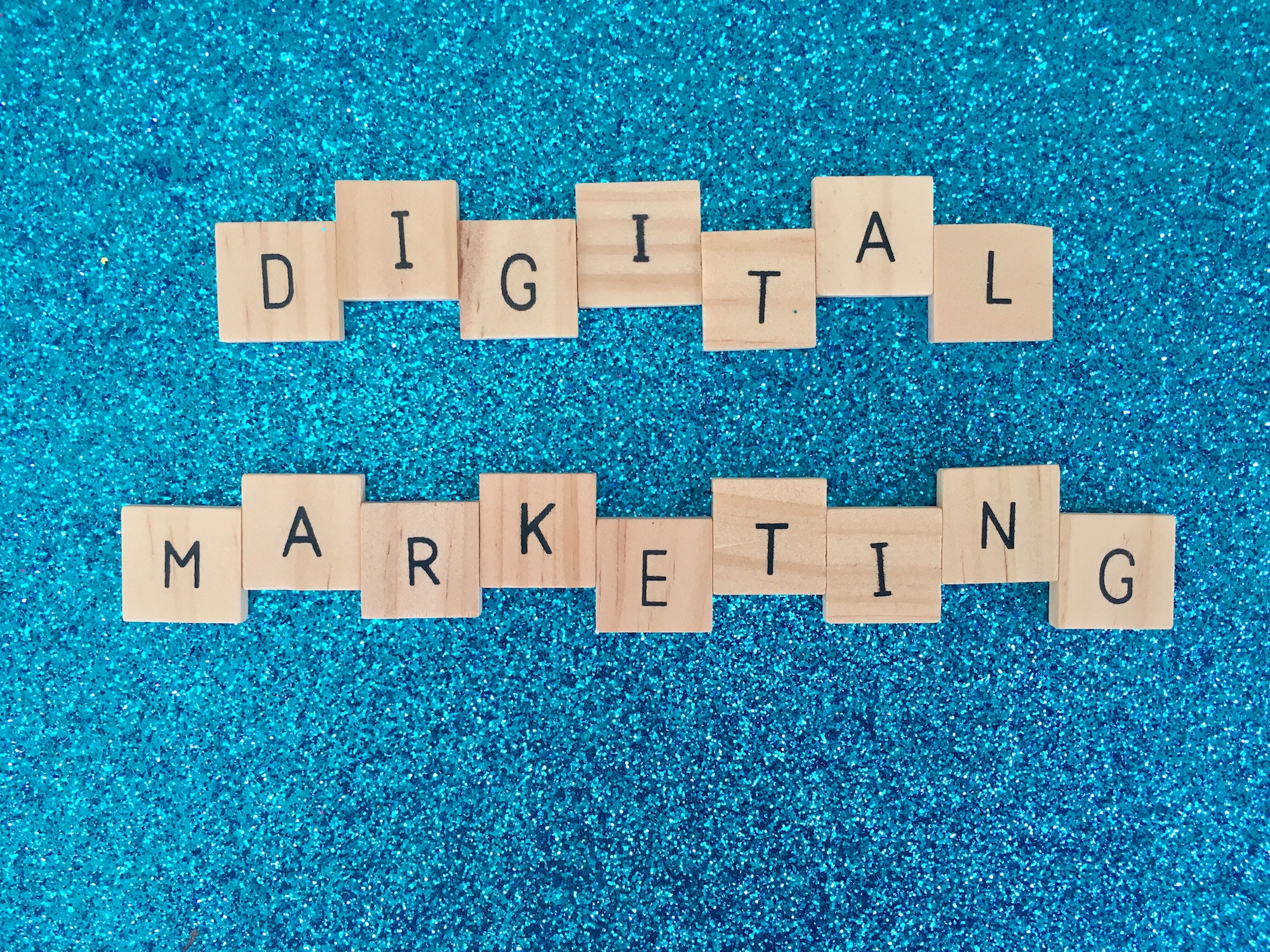Digital marketing written in scrabble letters with a blue background.
