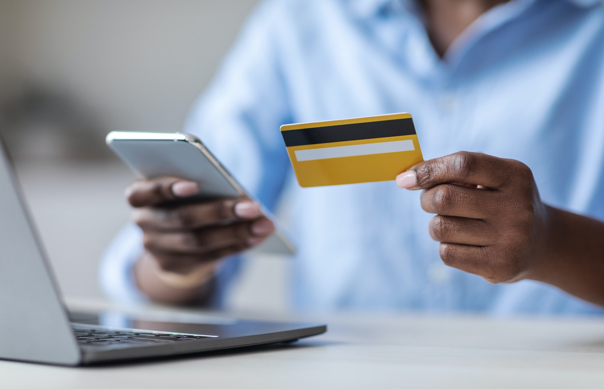 Woman using online payment service to complete transaction on her smartphone