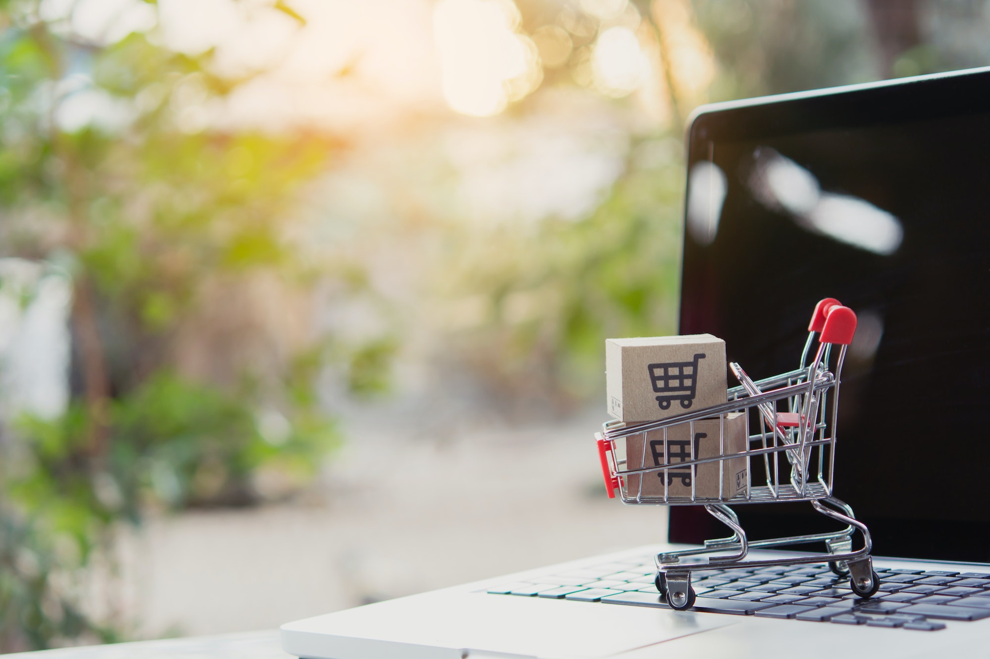 Shopping cart toy on keyboard. 11 eCommerce Marketplace Management Challenges.