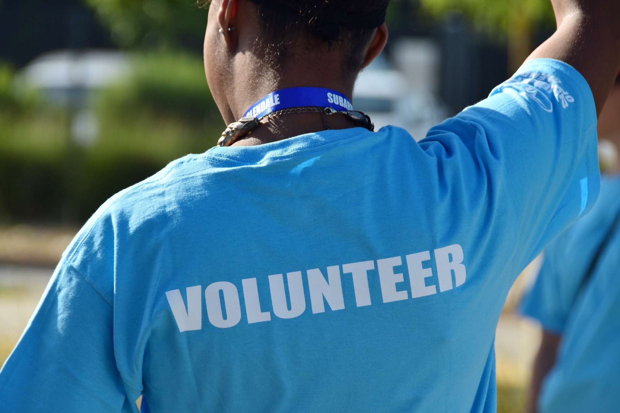 Volunteer written on the back of a volunteers t-shirt.