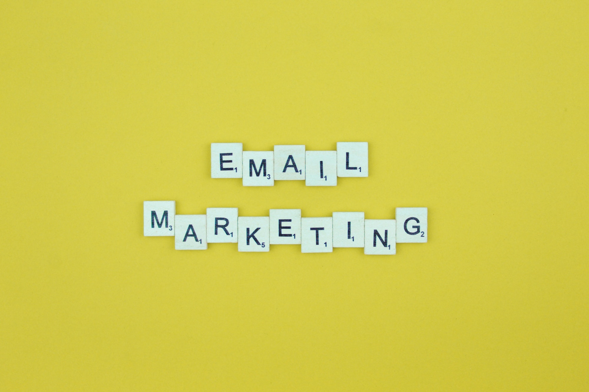 Email marketing- scrabble letters word on a yellow background.