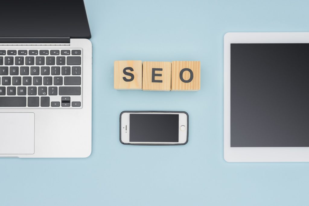 View of SEO letters with electronics from above.