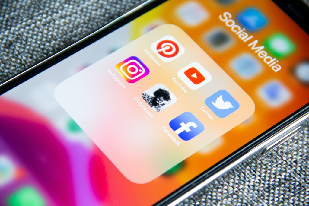 Social Media for Lead Generation: Develop an Effective Social Media Strategy A phone with social media icons.