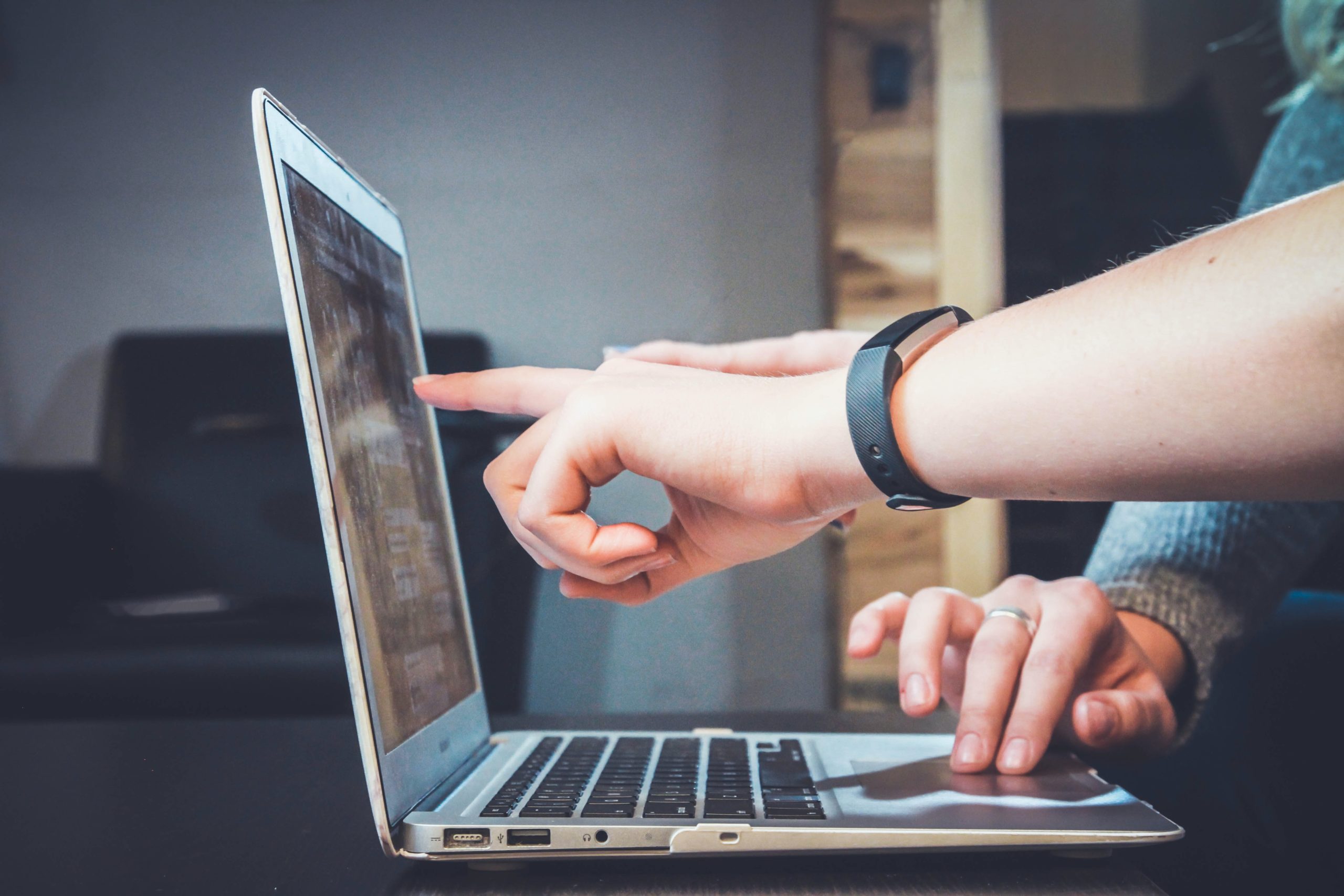 two people working on content marketing on a laptop.