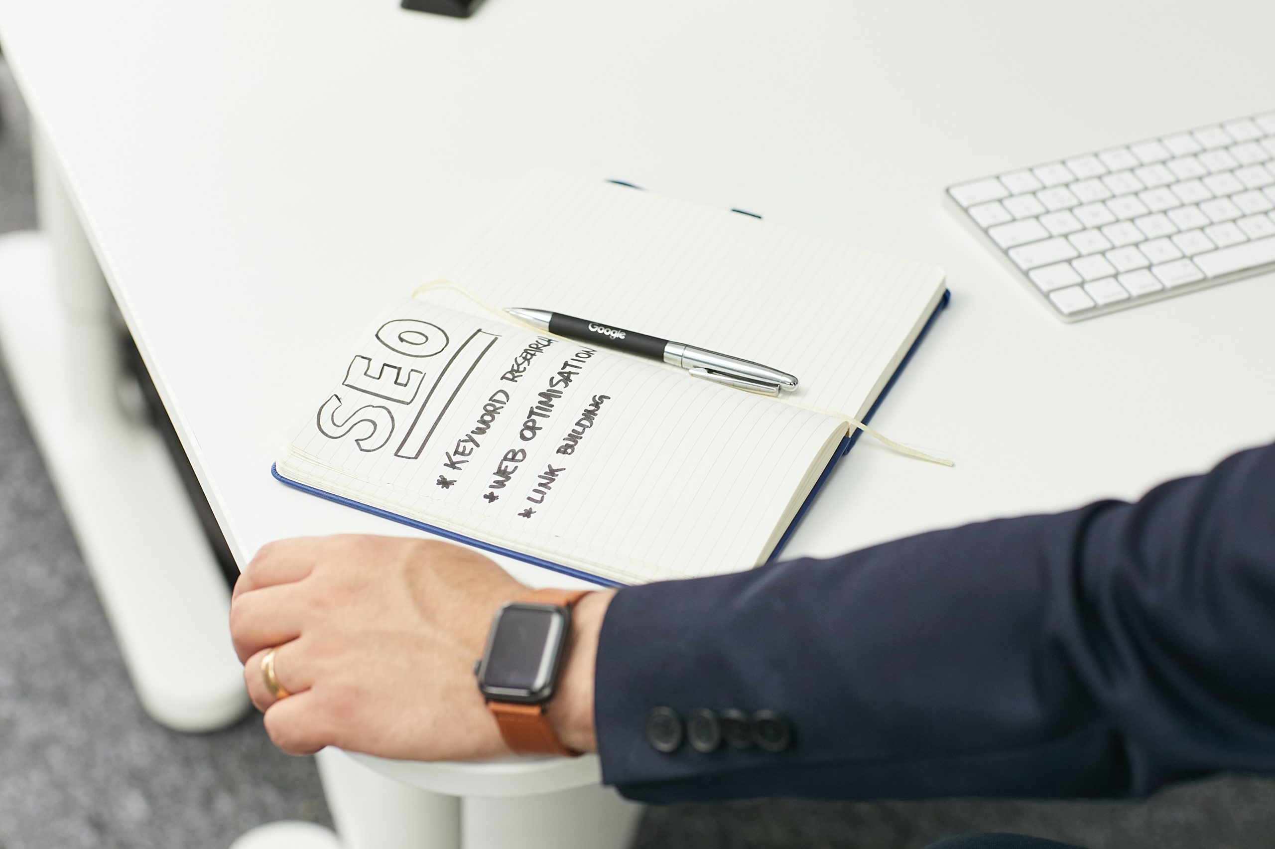 A notebook with seo written in it about referral marketing.
