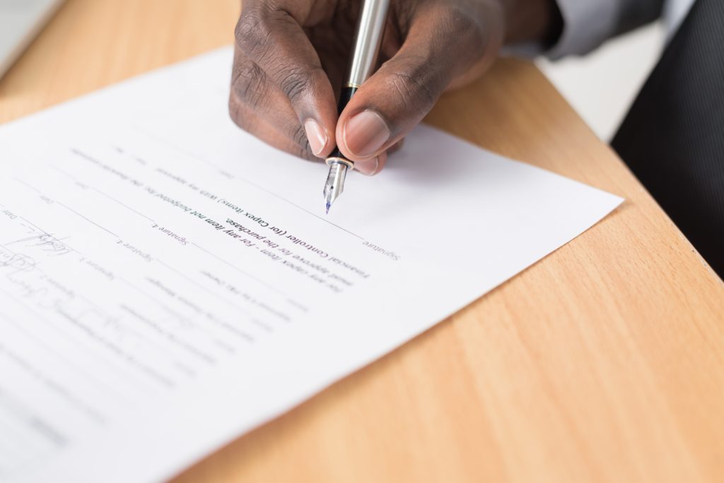 website-contract A man writing a legal contract for a website