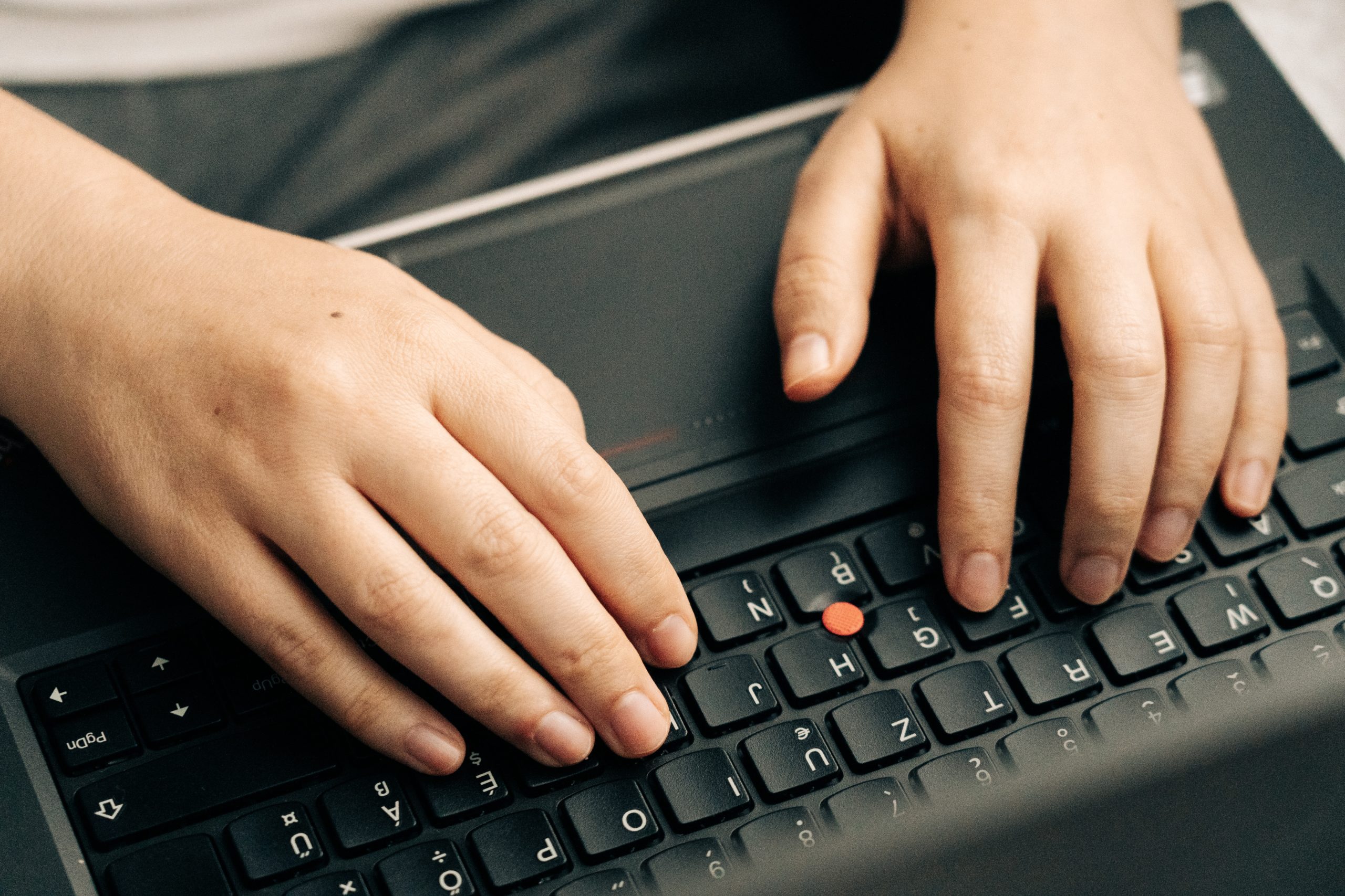 A man typing keywords on his laptop