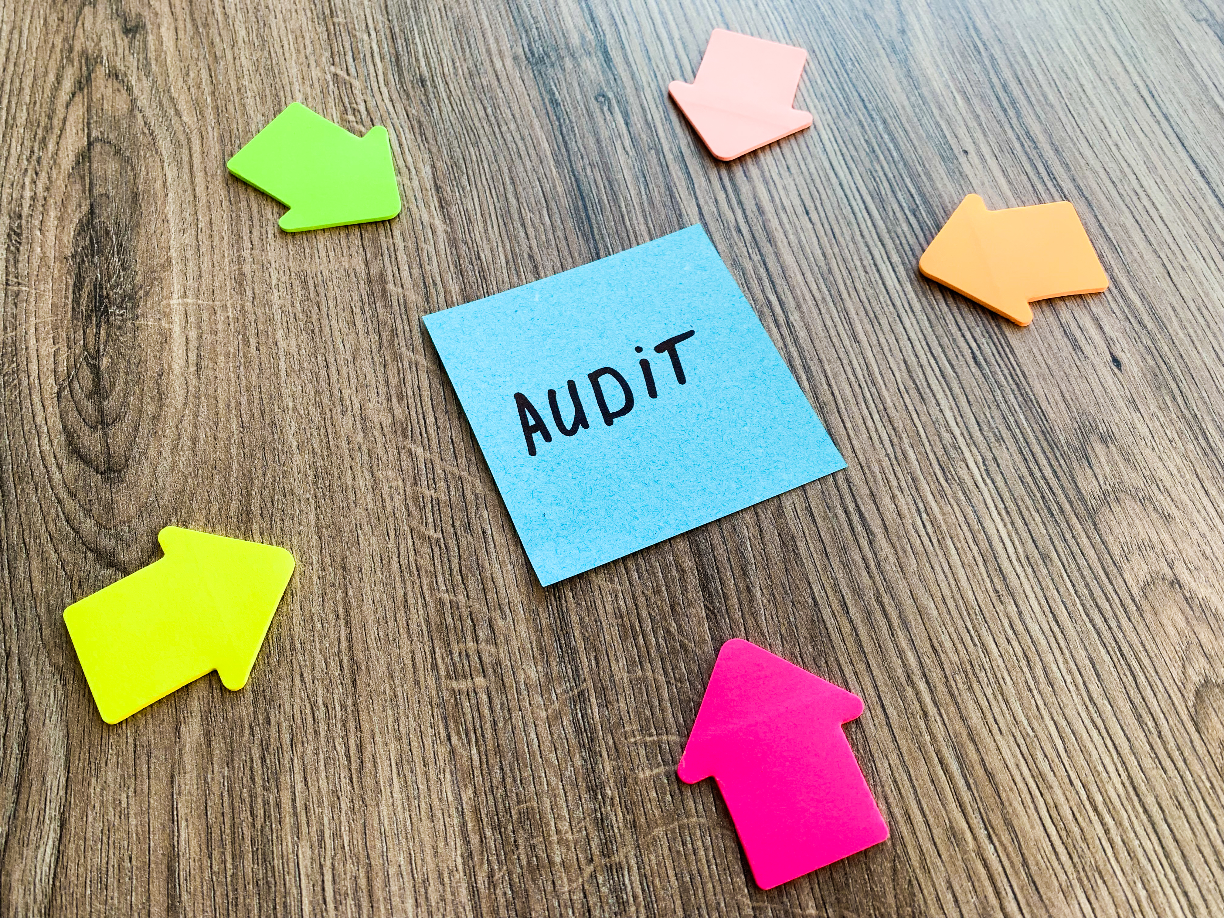 Paper stick with words audit on desk.  The 7-Step SEO Audit Checklist For 2023.