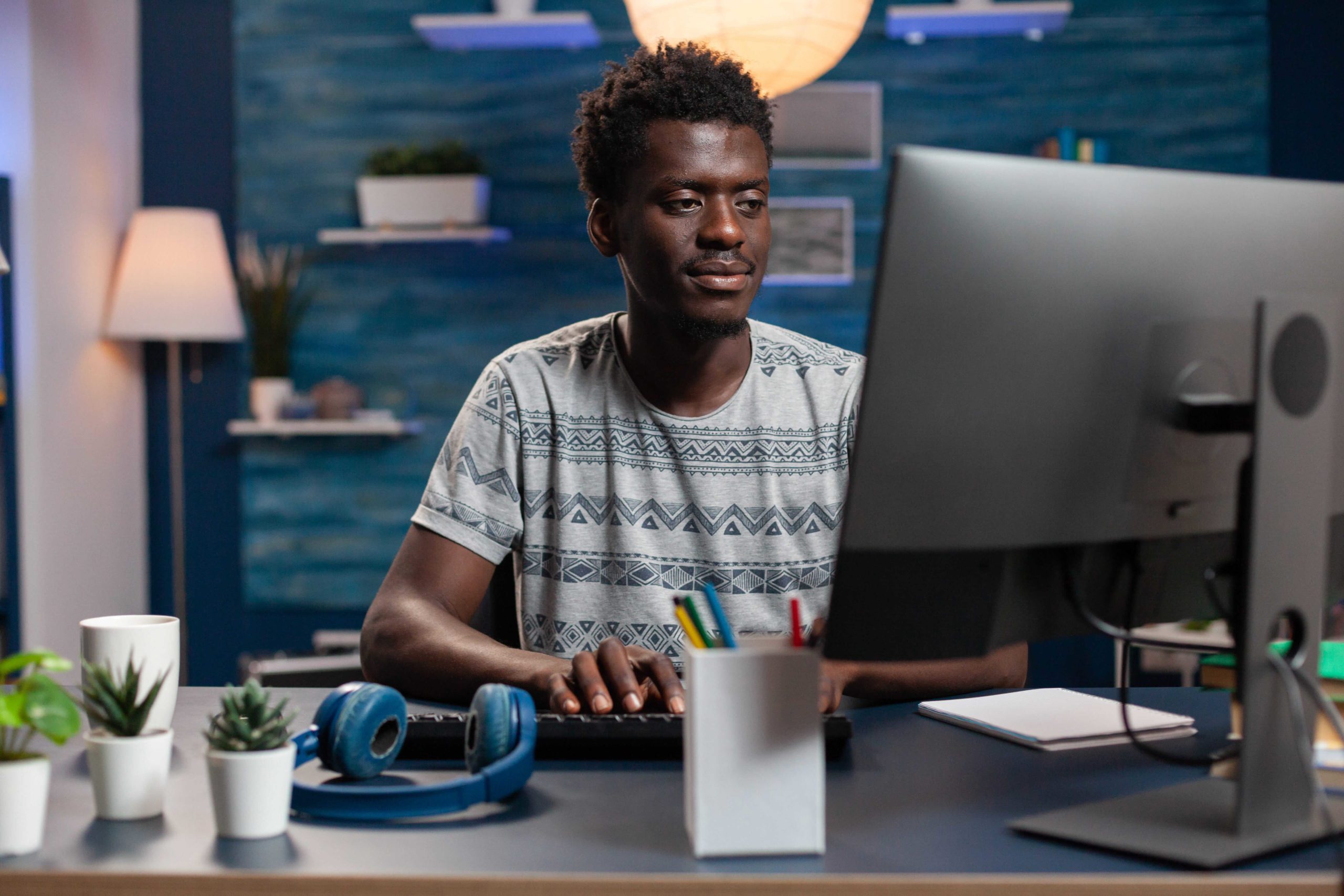 Employee Using Computer For Strategies To Stand Out From Competitors In SAAS Software Marketing.