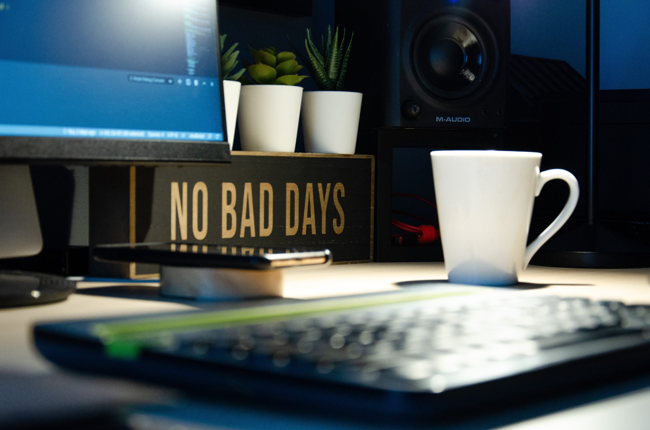 A work desk with a computer that says "no bad days".