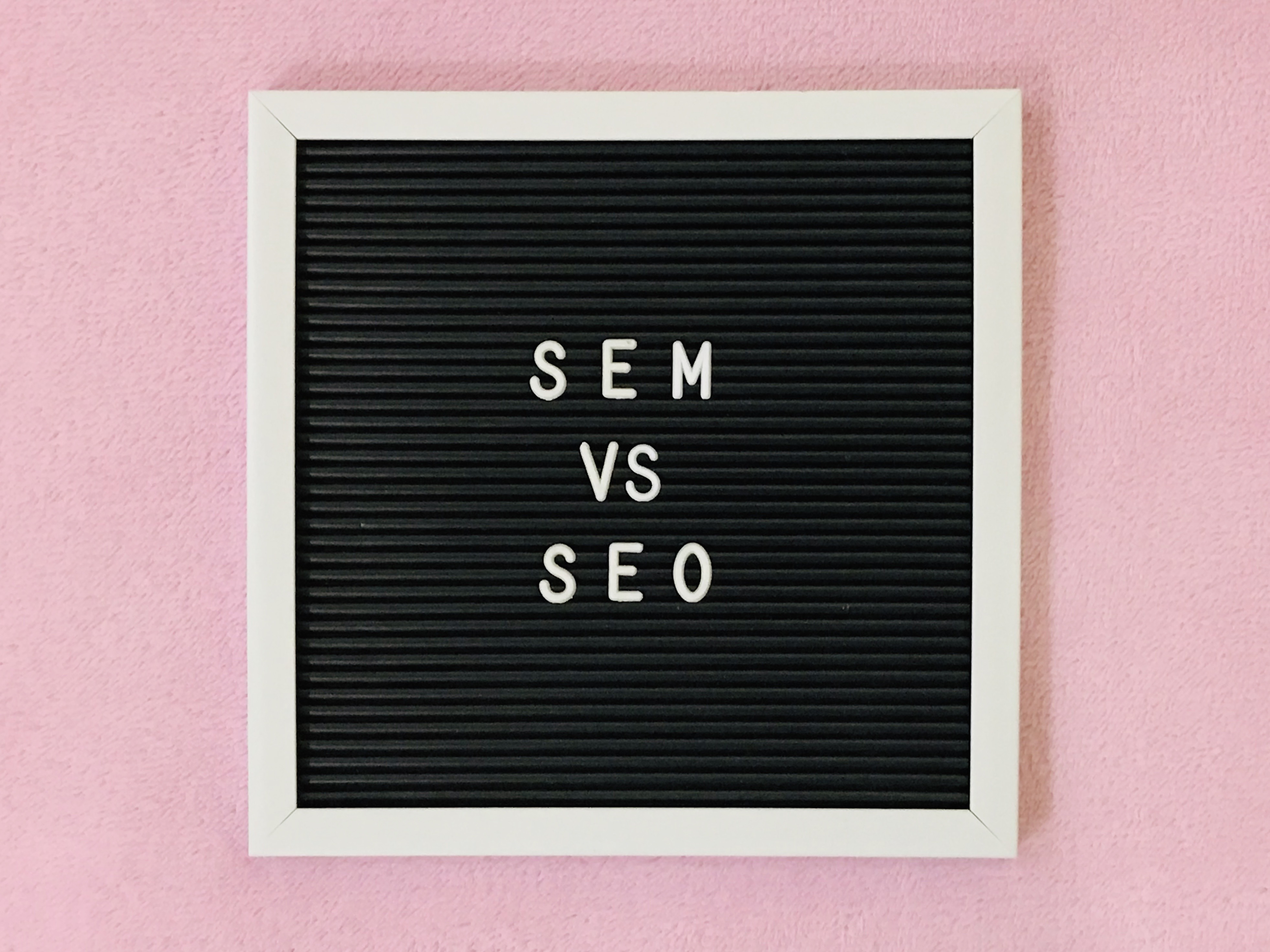SEO vs. SEM letters on a black background.