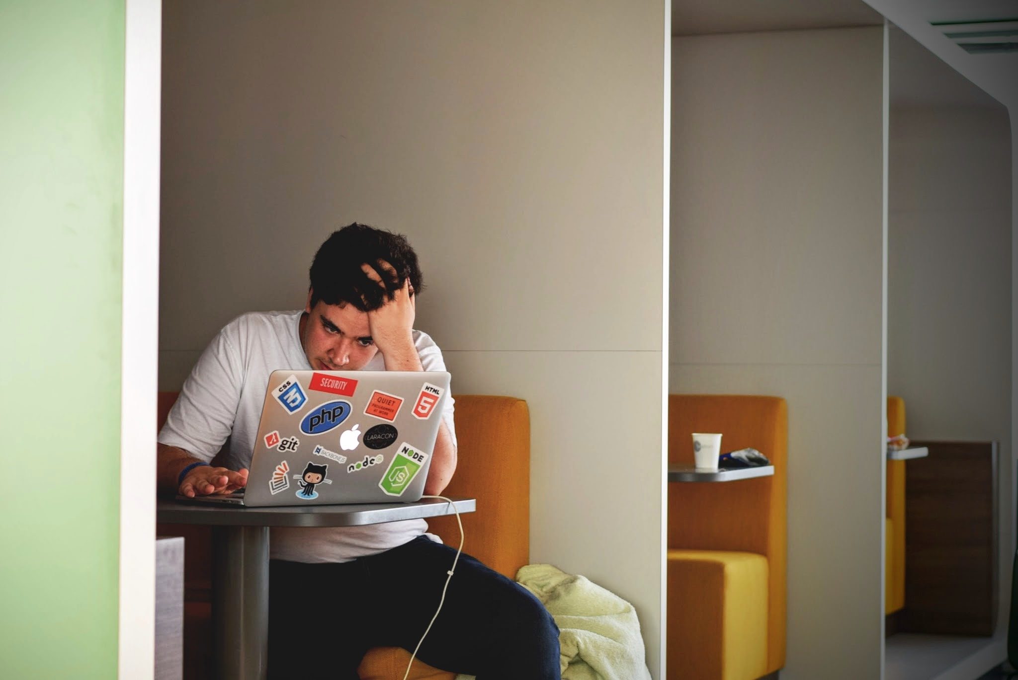 A frustrated man on a laptop.