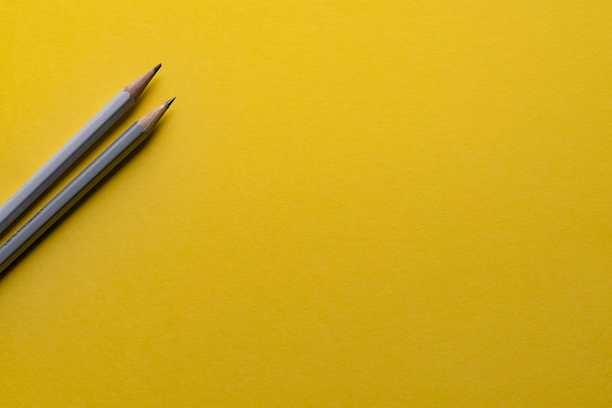 Crafting an irresistible brand. Yellow background with pencils on it.