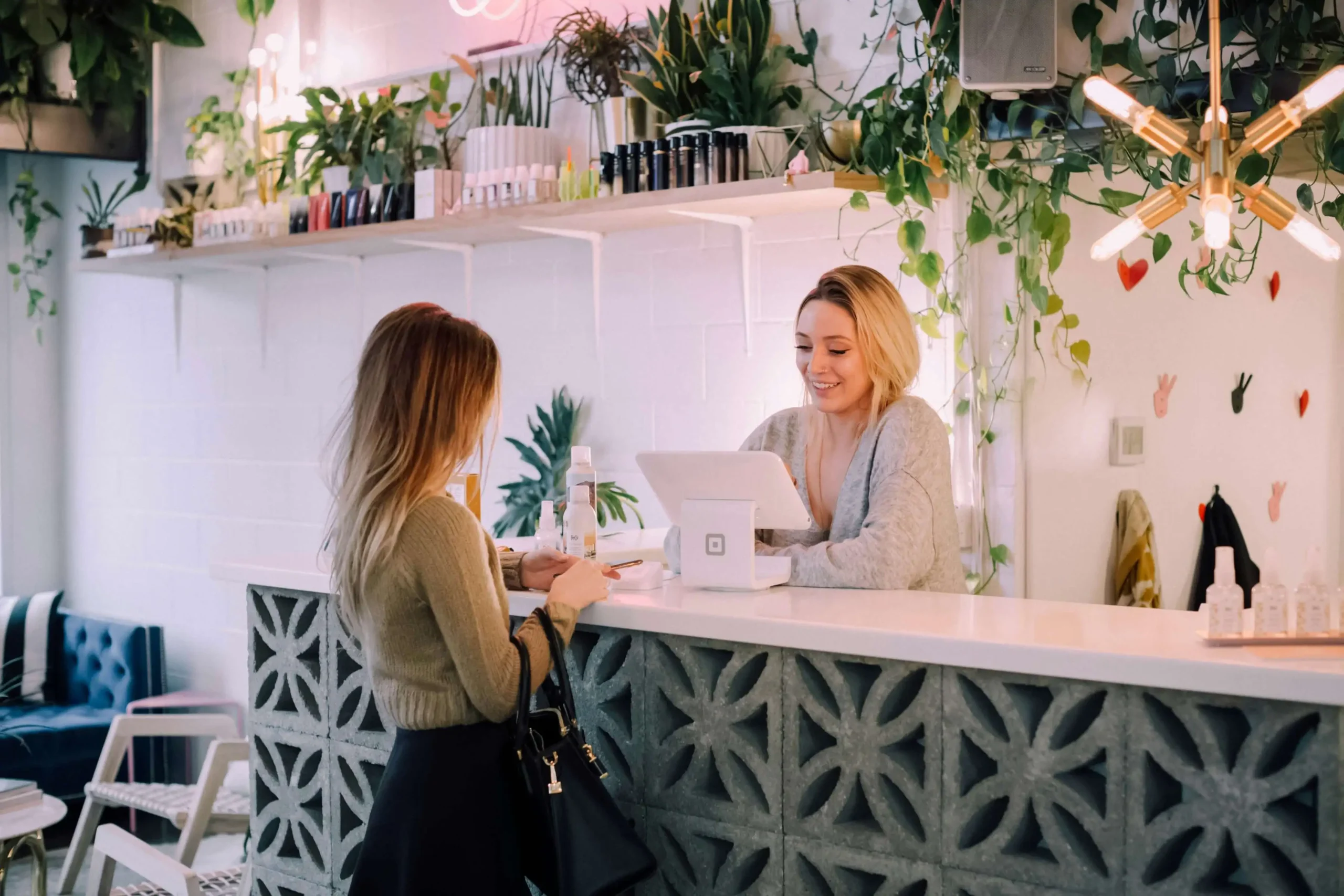 A cashier in a brick & mortar store using a Square payment processor