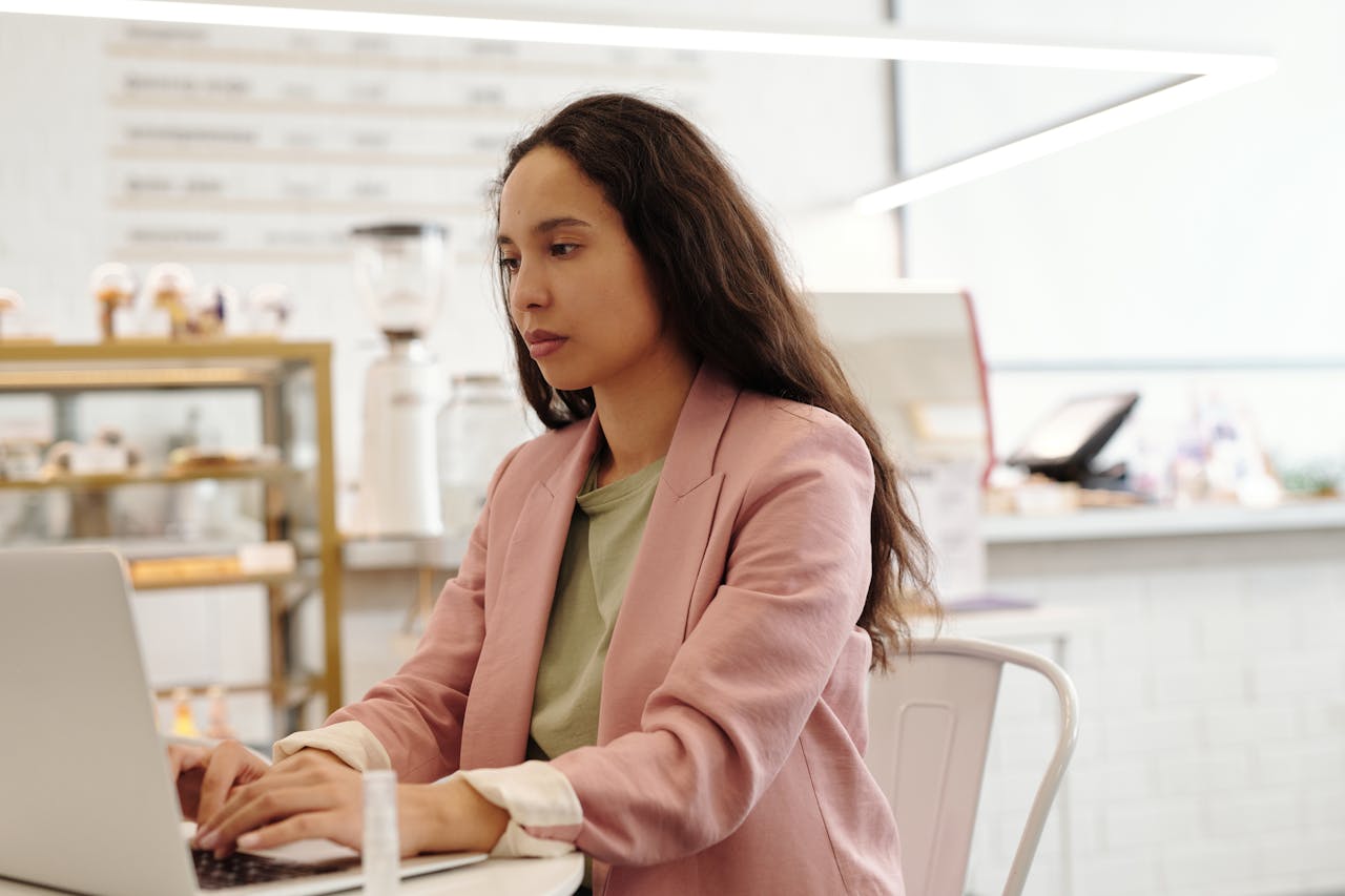 6 Recent Changes To Be Aware Of For Business Messaging. Woman workin on computer.